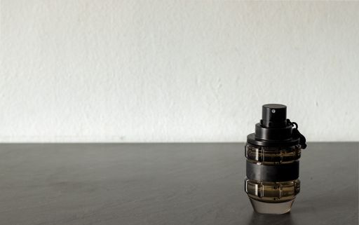 A grenade shaped perfume bottle with space for text