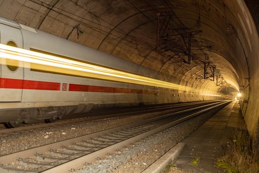 Deutsche Bahn train passes through the tunnel. Light strip of the train runs through the whole tunnel.