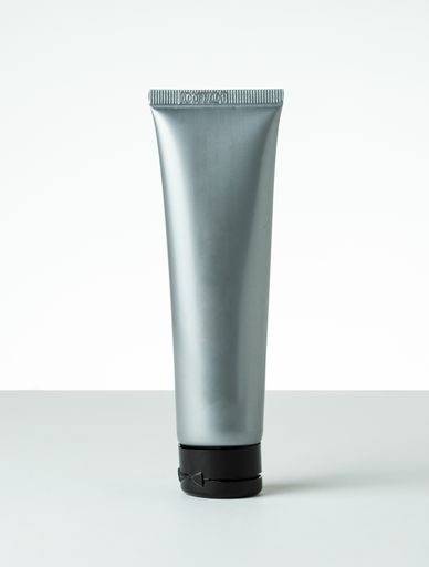 a clear silver cosmetics bottle