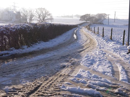 Country lane in England covered in snow wide landscape shot