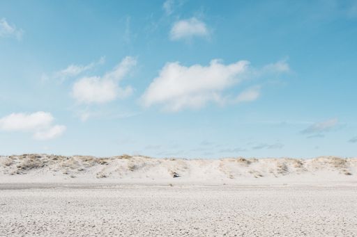 A wide angle shot of white plain under a blue sky at daytime