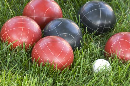 A closeup of colourful bocce balls on the lawn under the sunlight