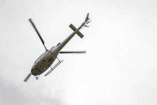 A shot of a helicopter from below against a white sky