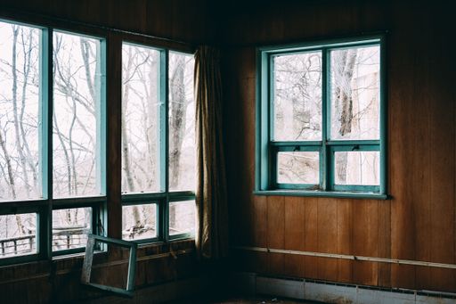 An interior of an abandoned building with broken windows