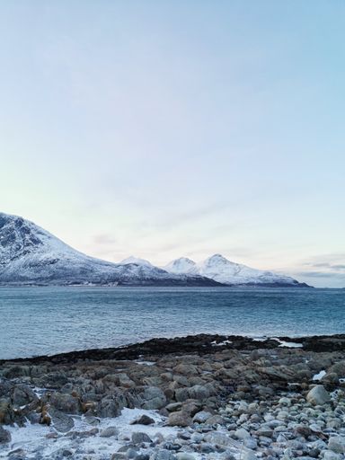 A vertical shot of the snowy landscapes in Grotfjord, Kvaloya Island, Tromso, Norway