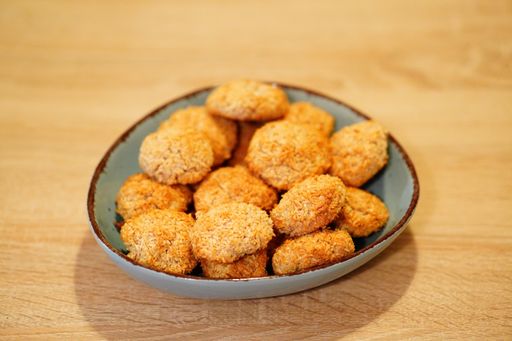 A selective focus shot of deliciously baked coconut chip cookies on a plate