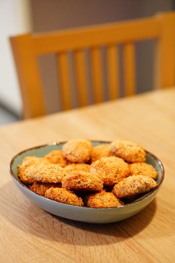 A selective focus shot of deliciously baked coconut chip cookies on a plate