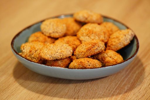 A selective focus shot of deliciously baked coconut chip cookies on a plate