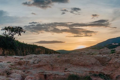 A beautiful shot of the sunset over a rocky mountain