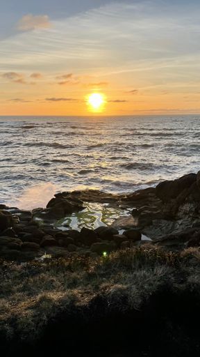 A vertical shot of abeautiful orange sunset over the sea.