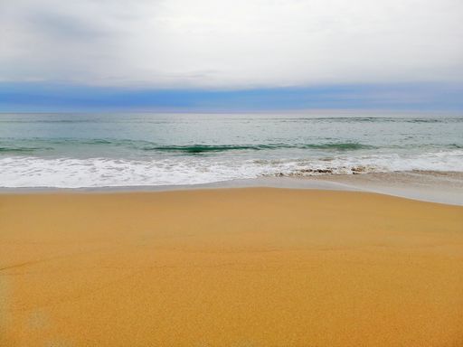 A mesmerizing scenery of ocean waves moving towards the shore in San Sebastian town, Spain