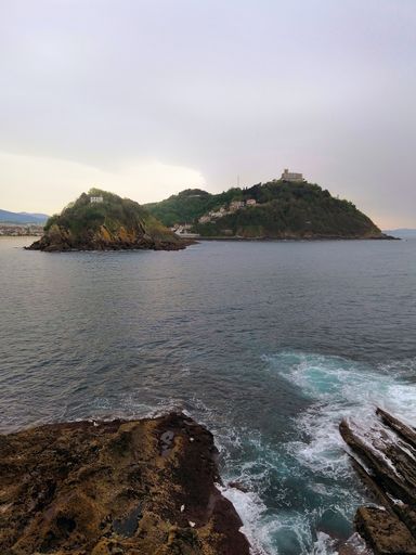 A vertical high angle shot of a mesmerizing beach scenery in San Sebastian, Spain