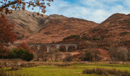 A landscape of a bridge in the deserted hills in autumn