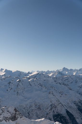 A vertical shot of snowy mountains in Engelberg, Switzerland