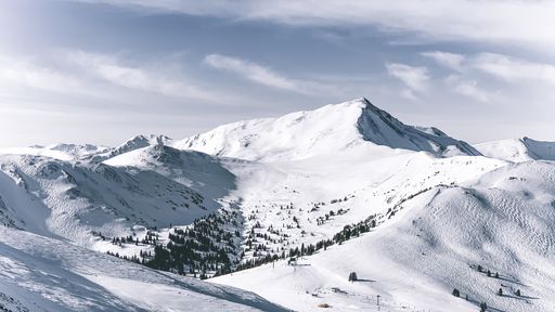 A closeup shot of mountains covered in snow at daytime