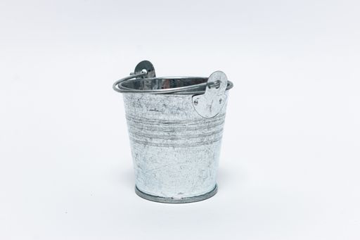 A closeup shot of a rusty metal bucket isolated on a white background