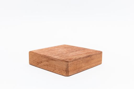 A closeup shot of a wooden chopping board isolated on a white background