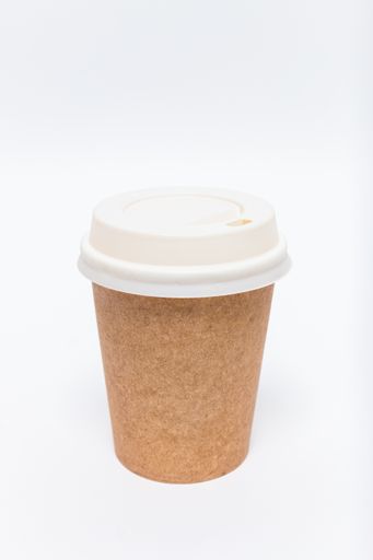 A vertical closeup shot of a plastic coffee cup on a white background