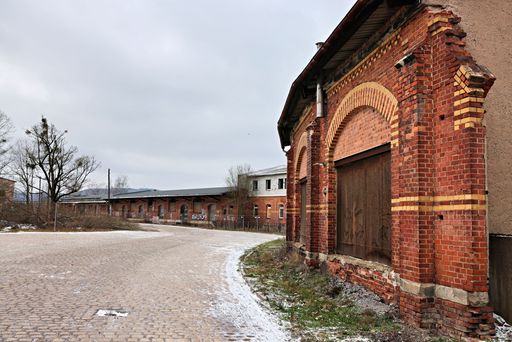 An old abandoned urban railway station with crumbling walls and a broken window