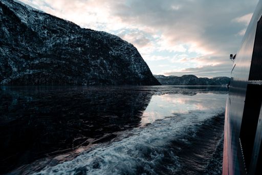 A beautiful shot of a fjord near cliffs from a boat window in Bergen, Norway