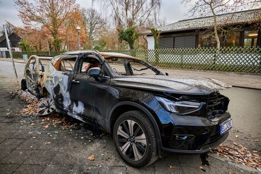 Berlin, Germany - December 12, 2022: Wrecks of two burnt out cars on the side of the road.