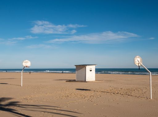 A beautiful view of basketball hoops on a sandy beach