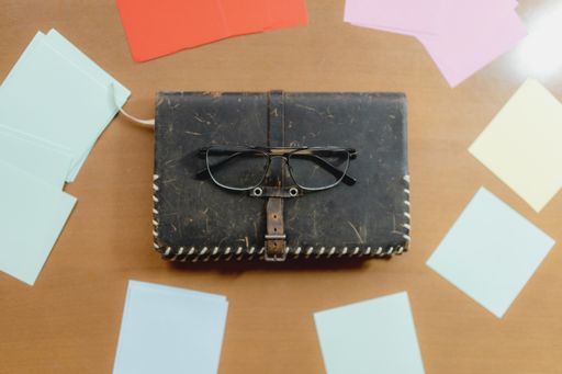 A top view of glasses on an old notebook on the table