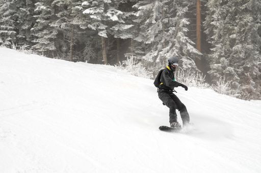 A snowboarder riding in the mountains