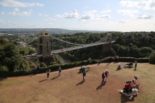 A beautiful shot of Clifton Down bridge and people looking at it in Bristol, UK