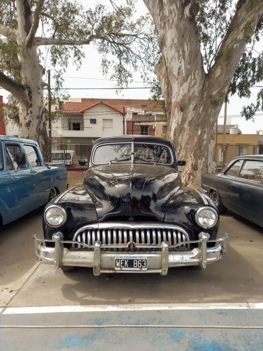 Lanus, Argentina - Sept 25, 2022: Old black 1940s Buick Eight Special four door sedan by GM in a park. AAA 2022 classic car show.