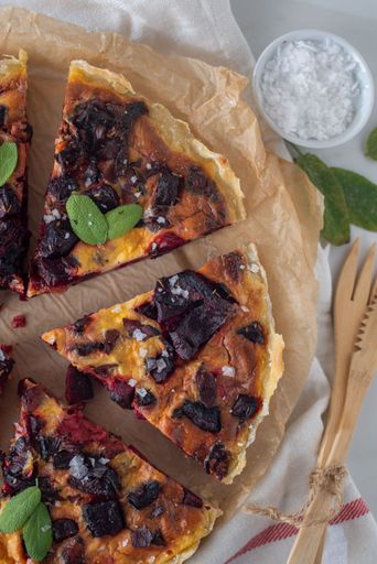 A delicious, fresh homemade tart with feta cheese and beetroot on a white background, ready to be enjoyed