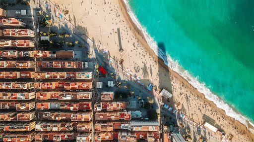 An aerial shot of high colorful buildings near the seacoast