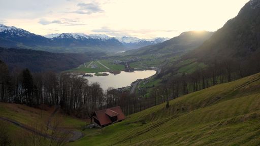 An aerial view of the beautiful Lake Lucerne and nearby fields and mountains in Switzerland