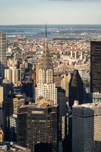 A drone shot of the Chrysler Building and skyscrapers in New York City on a sunny day, United States