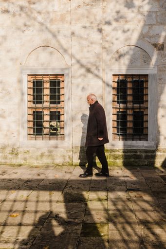 A man walking towards the mosque in Beylerbeyi, Istanbul, Turkey