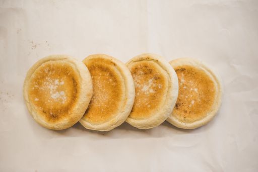 A closeup shot of pieces of round bread on a white background