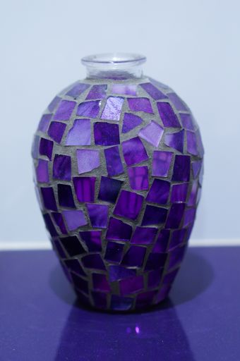 A vertical shot of a vase with purple crystals