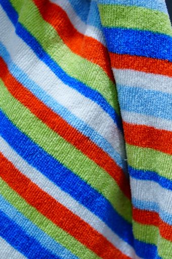 A vertical closeup shot of a colorful striped hand towel