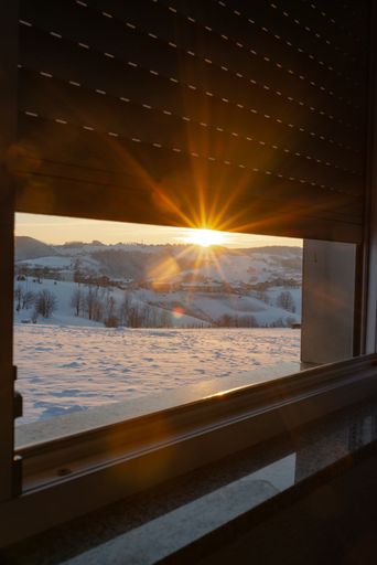 A scenic view of the sunbeams seen from a window during winter
