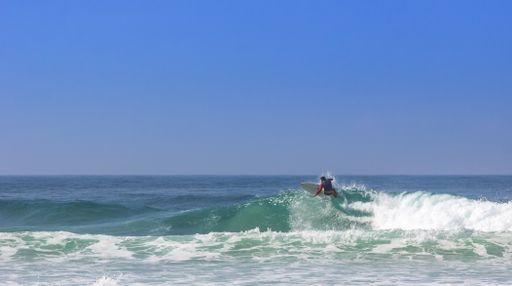 A surfer on beautiful sea waves on a sunny day