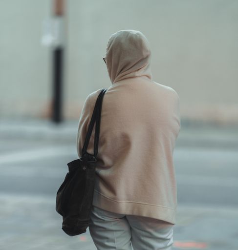 A selective focus of an adult woman waiting in a train station