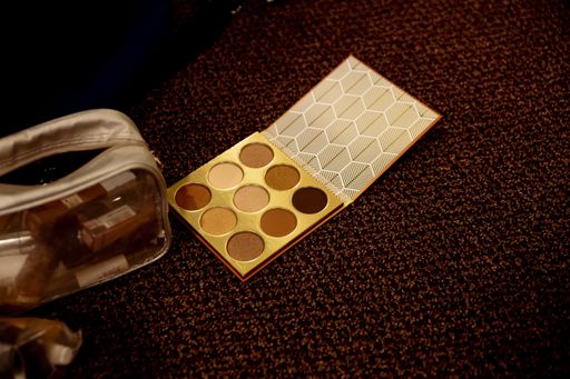 A high angle shot of an eyeshadow palette on the table under the light