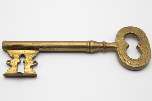 A vintage golden key isolated on a white background