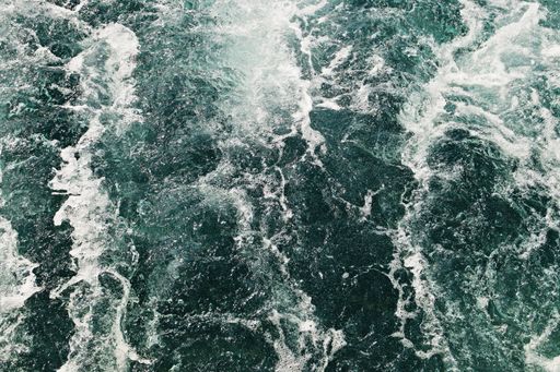 A high angle shot of the ocean waves moving towards the shore