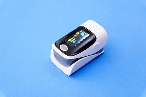 A pulse oximeter isolated a blue background