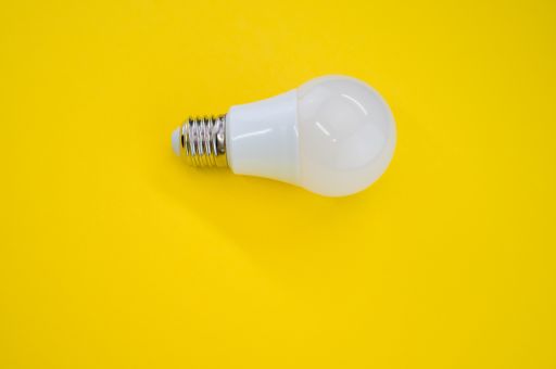 A closeup shot of a LED light bulb isolated on a yello background
