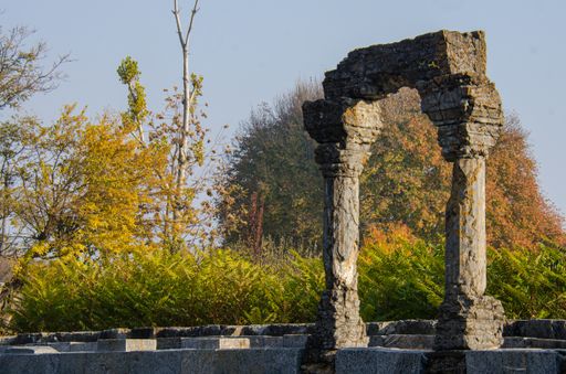 The ruins of the Martand Sun Temple under the sunlight and a blue sky in India