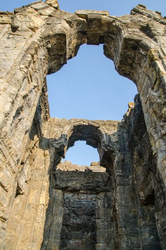 A vertical shot of the ruins of the Martand Sun Temple in India