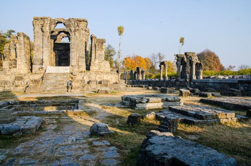 The ruins of the Martand Sun Temple under the sunlight and a blue sky in India