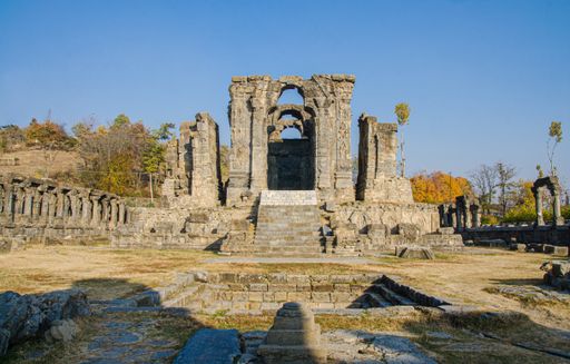 The ruins of the Martand Sun Temple under the sunlight and a blue sky in India